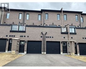 A building with a brick facade and black garage doors.