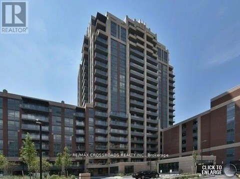 A tall building with a glass facade is the main focus of the image.