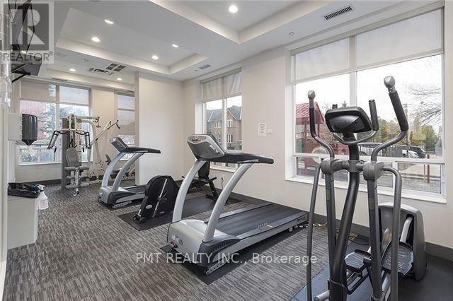 A gym with a treadmill, elliptical trainer and other exercise equipment.