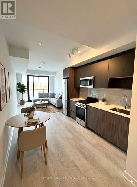 A modern kitchen with a dining table and chairs.