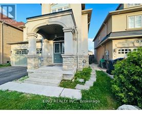 A house with a stone archway entrance and a sign that says King Realty Inc. Brokerage.