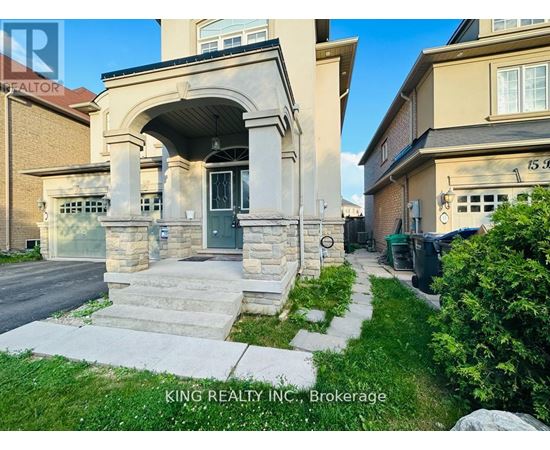 A house with a stone archway entrance and a sign that says King Realty Inc. Brokerage.