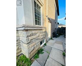 A stone wall is part of a home's exterior.