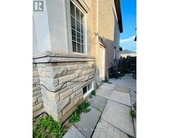 A stone wall is part of a home's exterior.