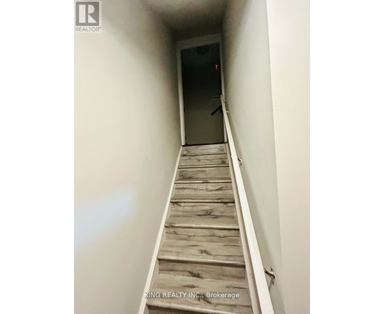 A staircase with wooden steps leading to a door.