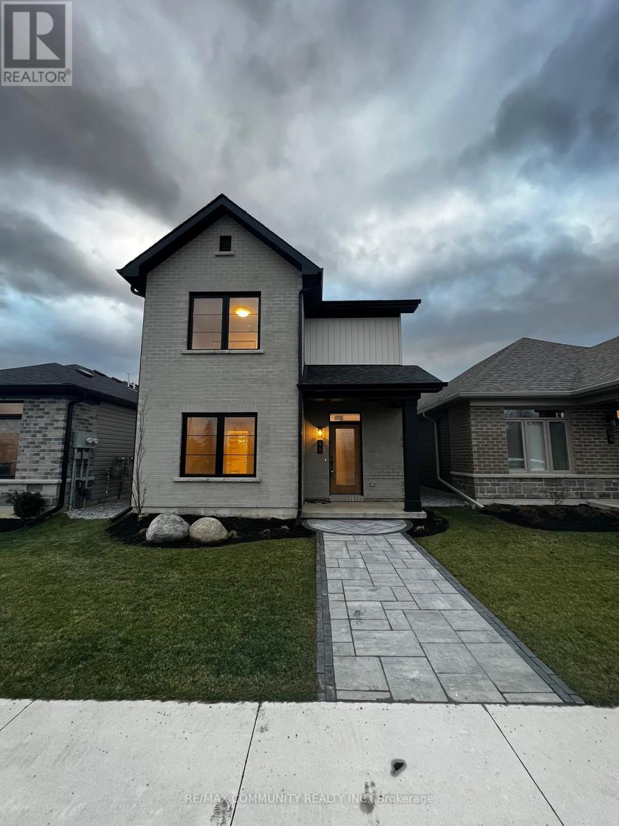 A house with a grey roof and a stone pathway leading to the front door.