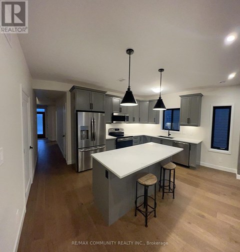 A kitchen with a white counter top and stools.