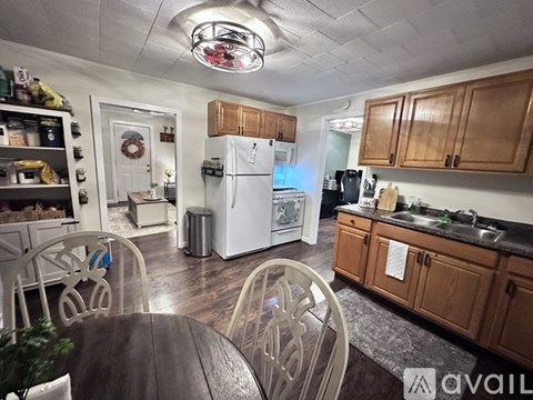 A kitchen with wooden cabinets and a white fridge.