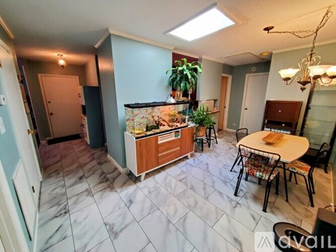 A kitchen with a table and chairs in the middle of the room.