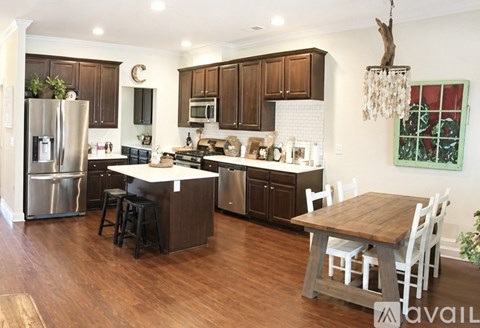 A kitchen with wooden cabinets and a white island.
