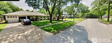 A house with a garage and a driveway is available for sale.