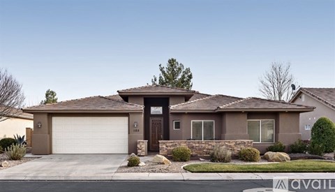 A house with a brown roof and a white garage door is for sale.