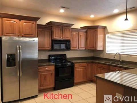 A kitchen with wooden cabinets and a stainless steel refrigerator.