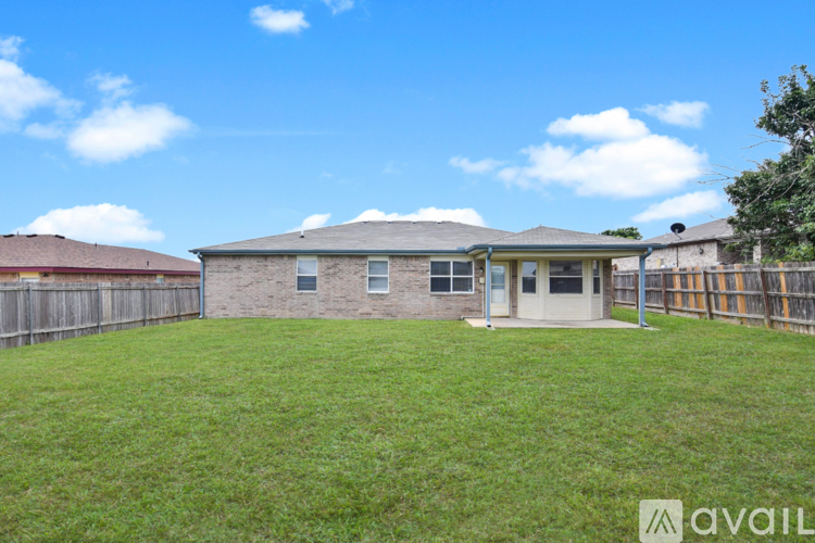 A house with a fence and a grassy yard is available for rent.