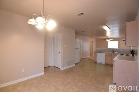 A kitchen area with a counter and a fridge.