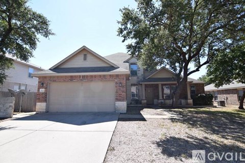 A house with a garage and a driveway is available for sale.