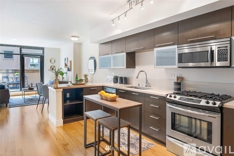 A modern kitchen with a stove top oven and a dining table.