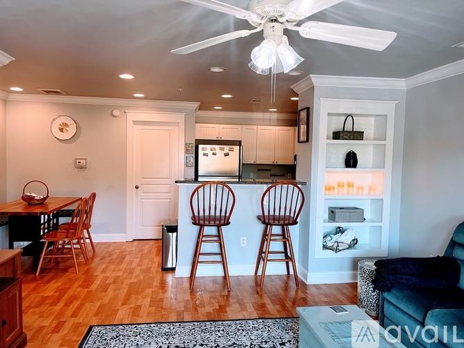 A kitchen with a dining table and chairs.