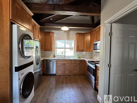 A kitchen with wooden cabinets and a washing machine.