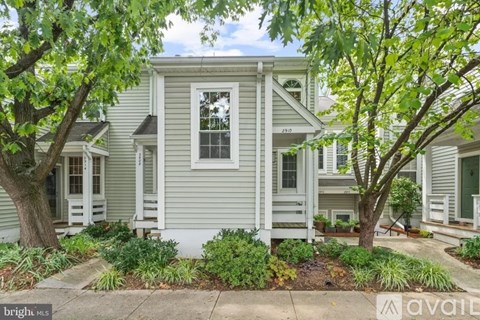 A house with a tree in front of it is for sale.