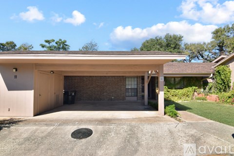 A two-car garage with a brick wall and a brown door.