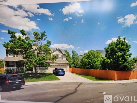 A street view image of a house with a car parked in front.