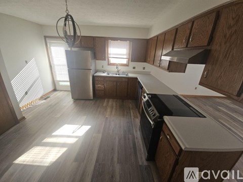 A kitchen with wooden cabinets and a black countertop.