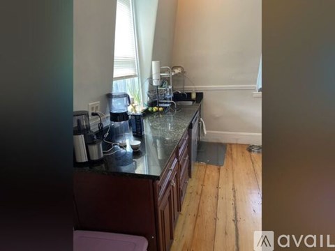 A kitchen counter with a sink and a window.
