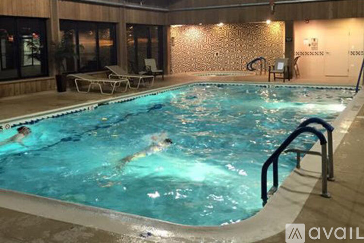 A swimming pool with people in it and a sign that says "available".