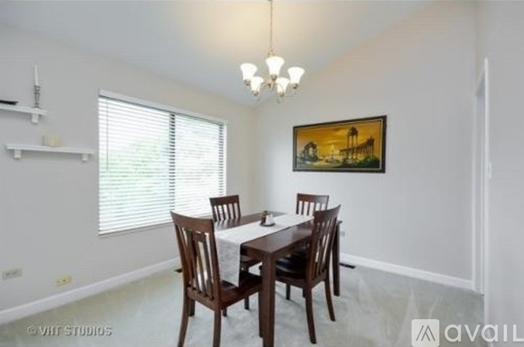 A dining room with a table set for four.