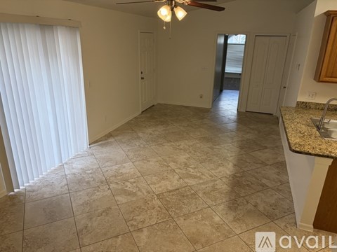 A kitchen area with a counter and a fan.