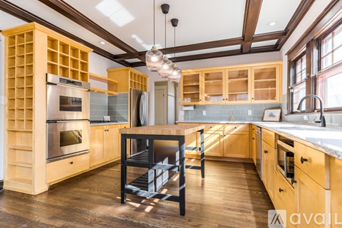 A modern kitchen with wooden cabinets and a central island.
