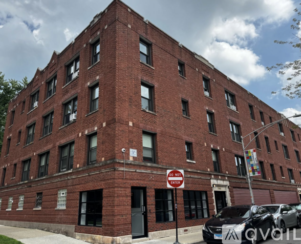 A red brick building with a "Do Not Enter" sign in front.
