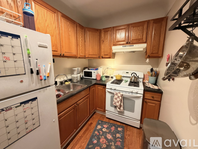 A kitchen with wooden cabinets and a white refrigerator.