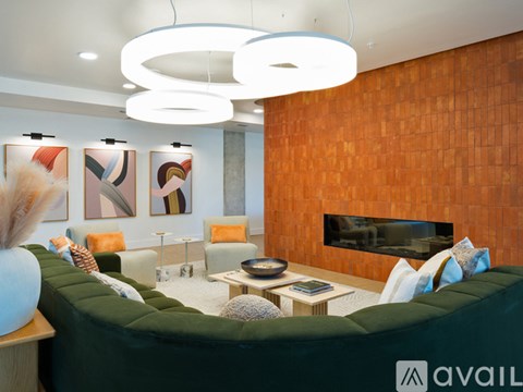 A living room with a green couch and a fireplace.
