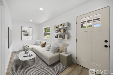 A living room with a white couch and a coffee table.