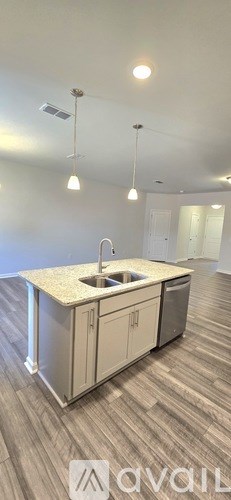 A kitchen with a sink and cabinets.