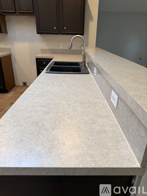 A kitchen counter with a sink and a stove.