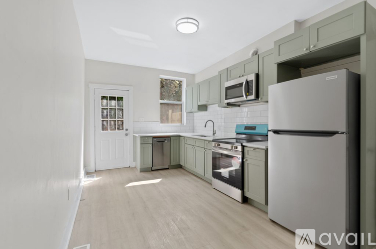 A kitchen with a white refrigerator and wooden floors.