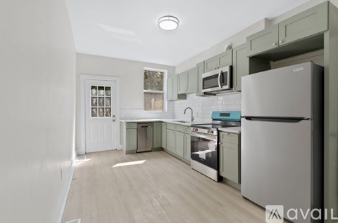 A kitchen with a white refrigerator and wooden floors.