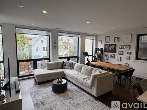 A living room with a couch, a coffee table, and a television.