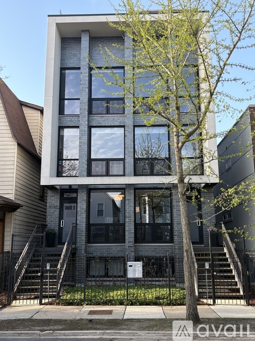 A modern building with a tree in front of it.