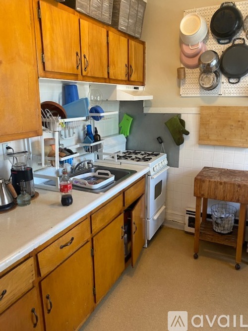 A kitchen with wooden cabinets and a white countertop.