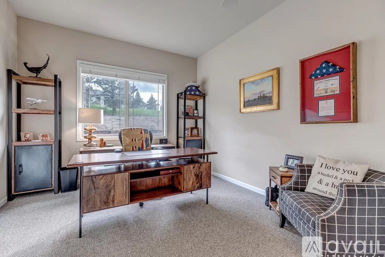 A living room with a grey sofa and a wooden cabinet.