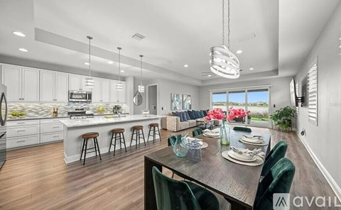 A modern kitchen with a dining table set for four.