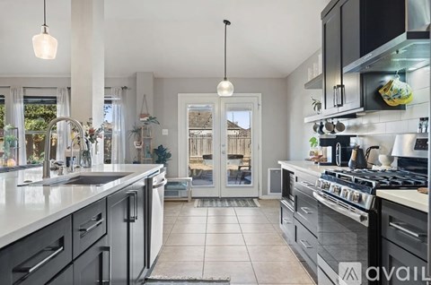 A kitchen with black cabinets and a white countertop.