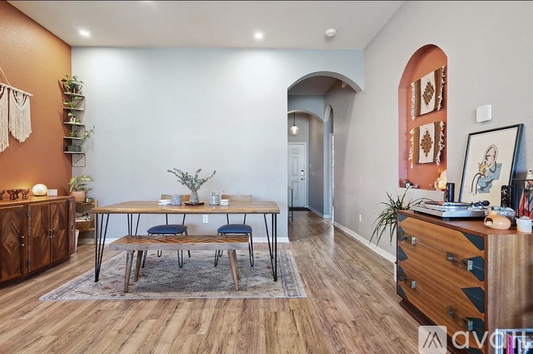 A dining room with a wooden table and chairs.