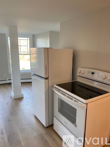 A kitchen with a white fridge and stove top oven.