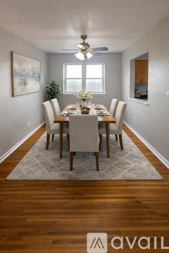 A dining room with a table set for six.