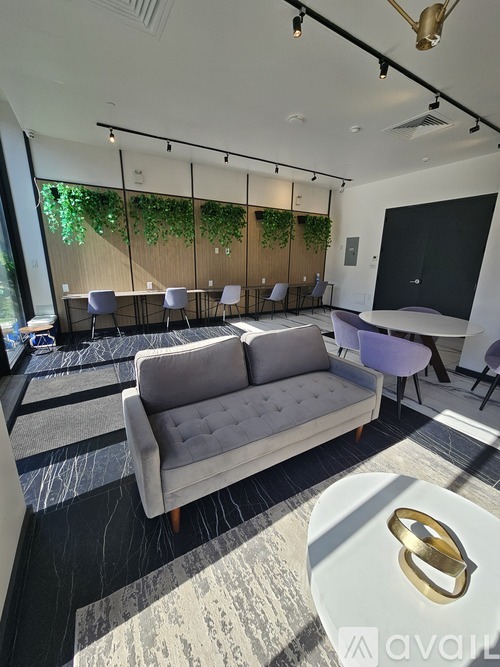 A modern living room with a grey sofa and a white coffee table.